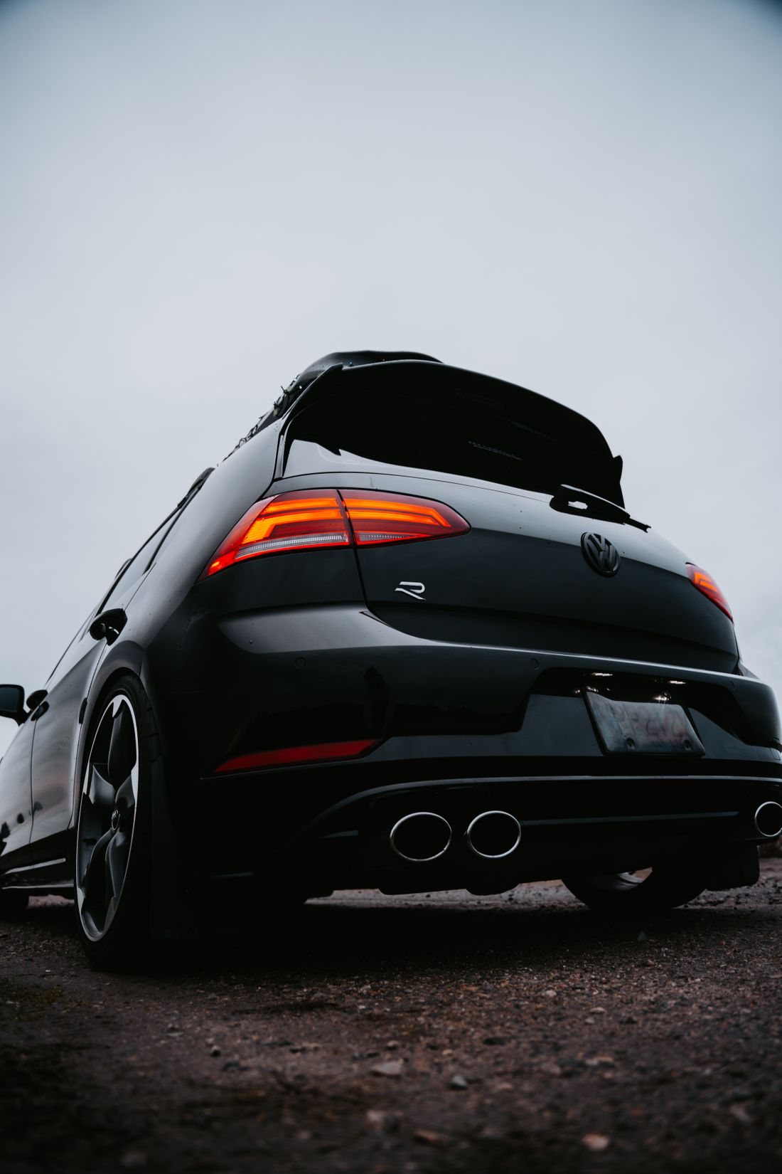Rear view of a black sport hatchback with dark tinted rear glass